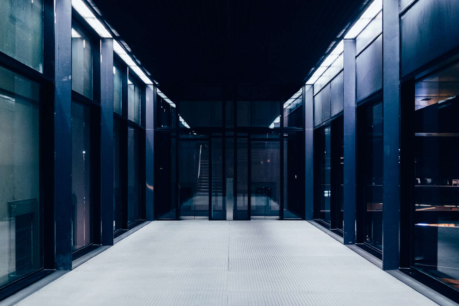 Long data hall corridor lit in blue